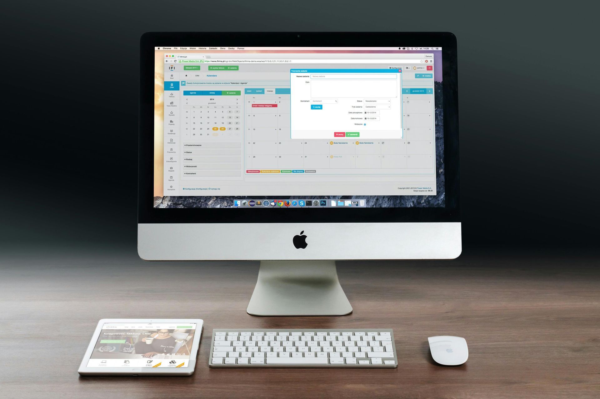 Apple computer displaying calendar with a tablet, keyboard, and mouse on a wooden desk.