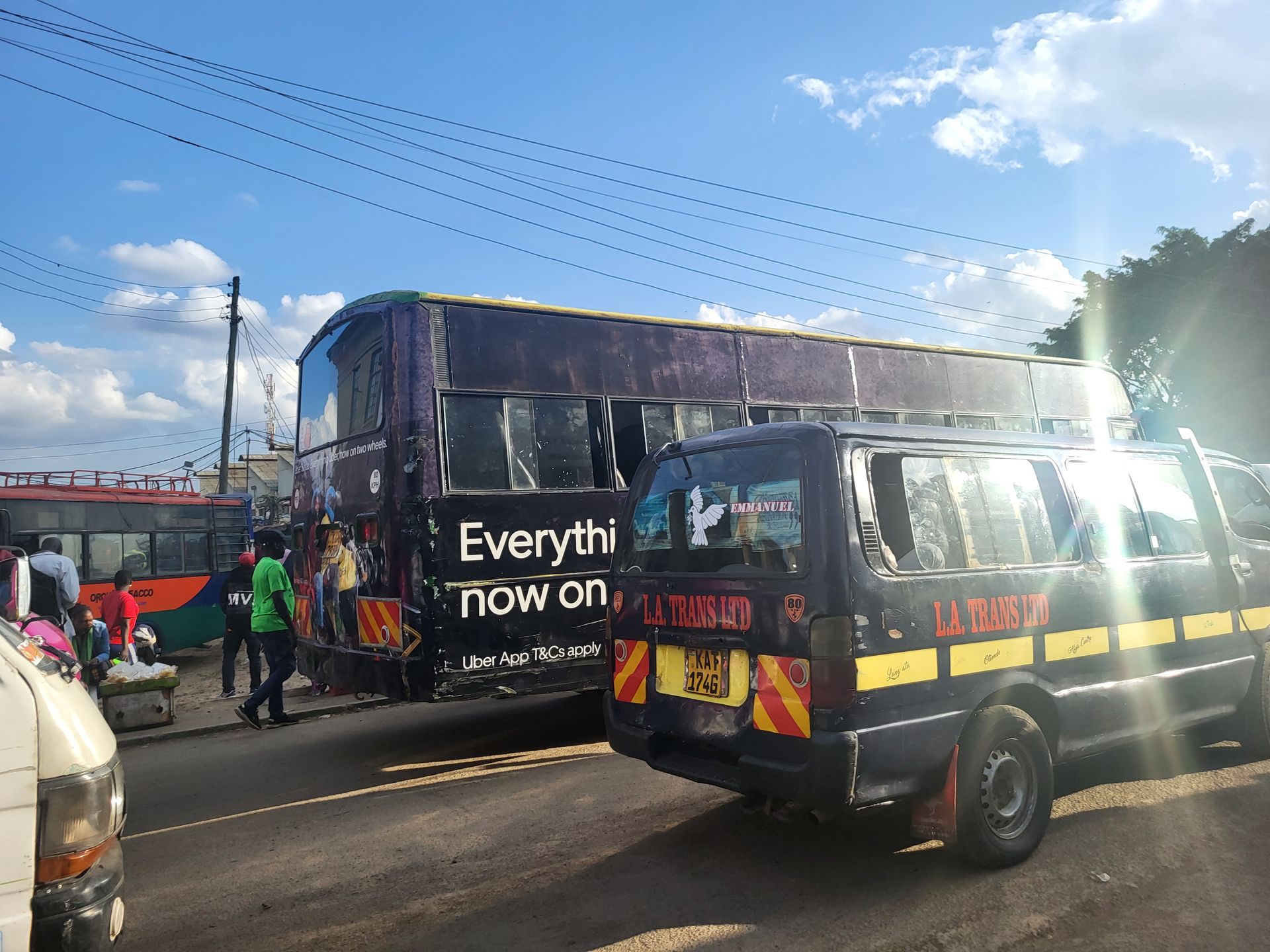 South African craft display: jewelry, flags, and carvings on a table in front of a brick wall.  Discovering Africa in the classroom