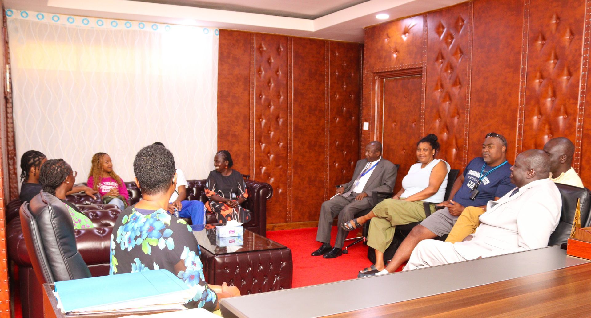 Students at desks watching a presentation on a screen, with colorful fabrics on the wall. Discovering Africa in the classroom