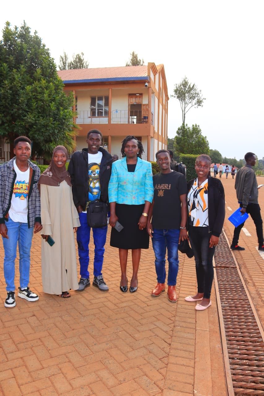 South African craft display: jewelry, flags, and carvings on a table in front of a brick wall.  Discovering Africa in the classroom