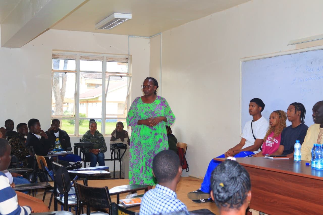 Children in a classroom are looking at a screen displaying a book. Desks and learning materials are visible.  Discovering Africa in the classroom