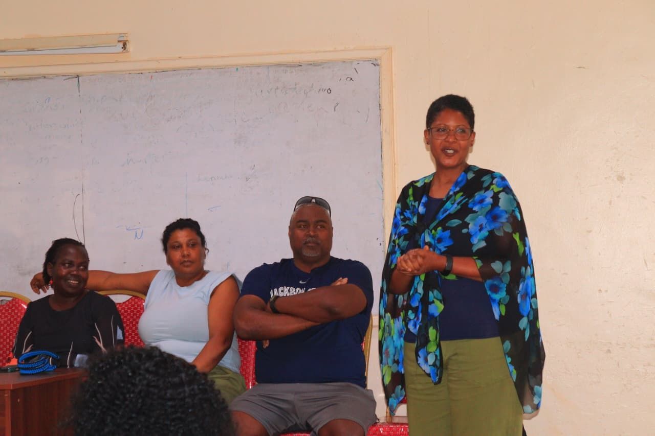 Students at desks watching a presentation on a screen, with colorful fabrics on the wall. Discovering Africa in the classroom