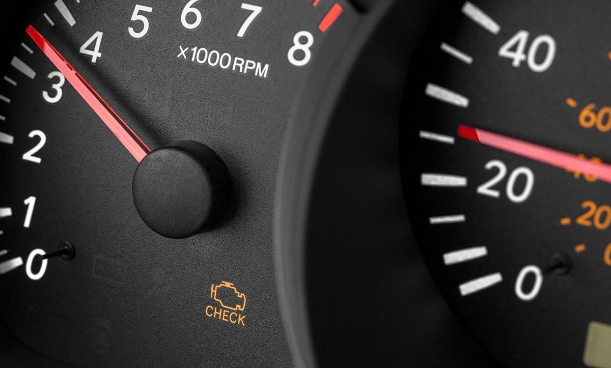 Red illuminated battery warning light on a car dashboard.