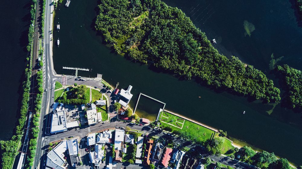 Aerial View of a River and Island, With Buildings and a Road — Diamond Real Estate QLD in North Lakes, QLD