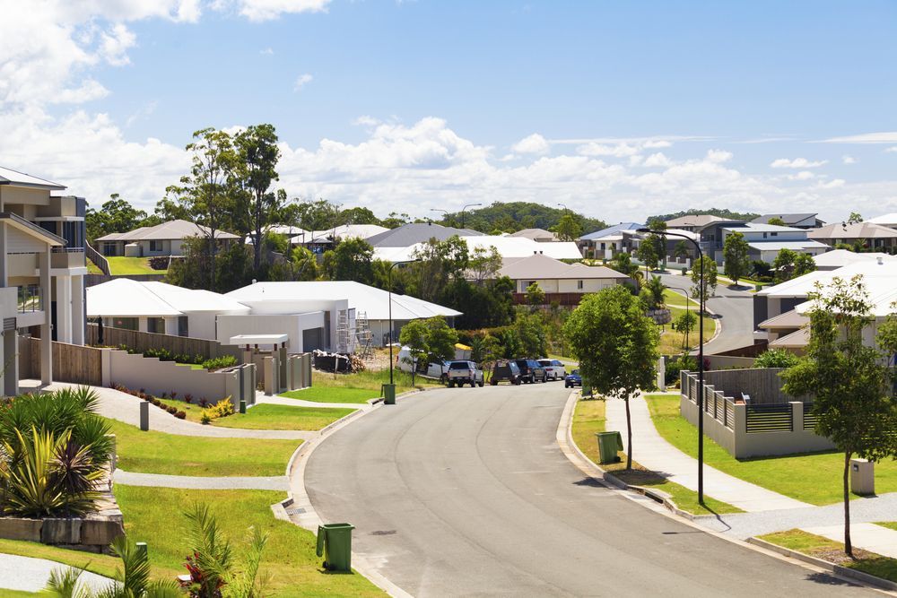 Suburban Street With Houses, Trees, and Blue Sky — Diamond Real Estate QLD in North Lakes, QLD