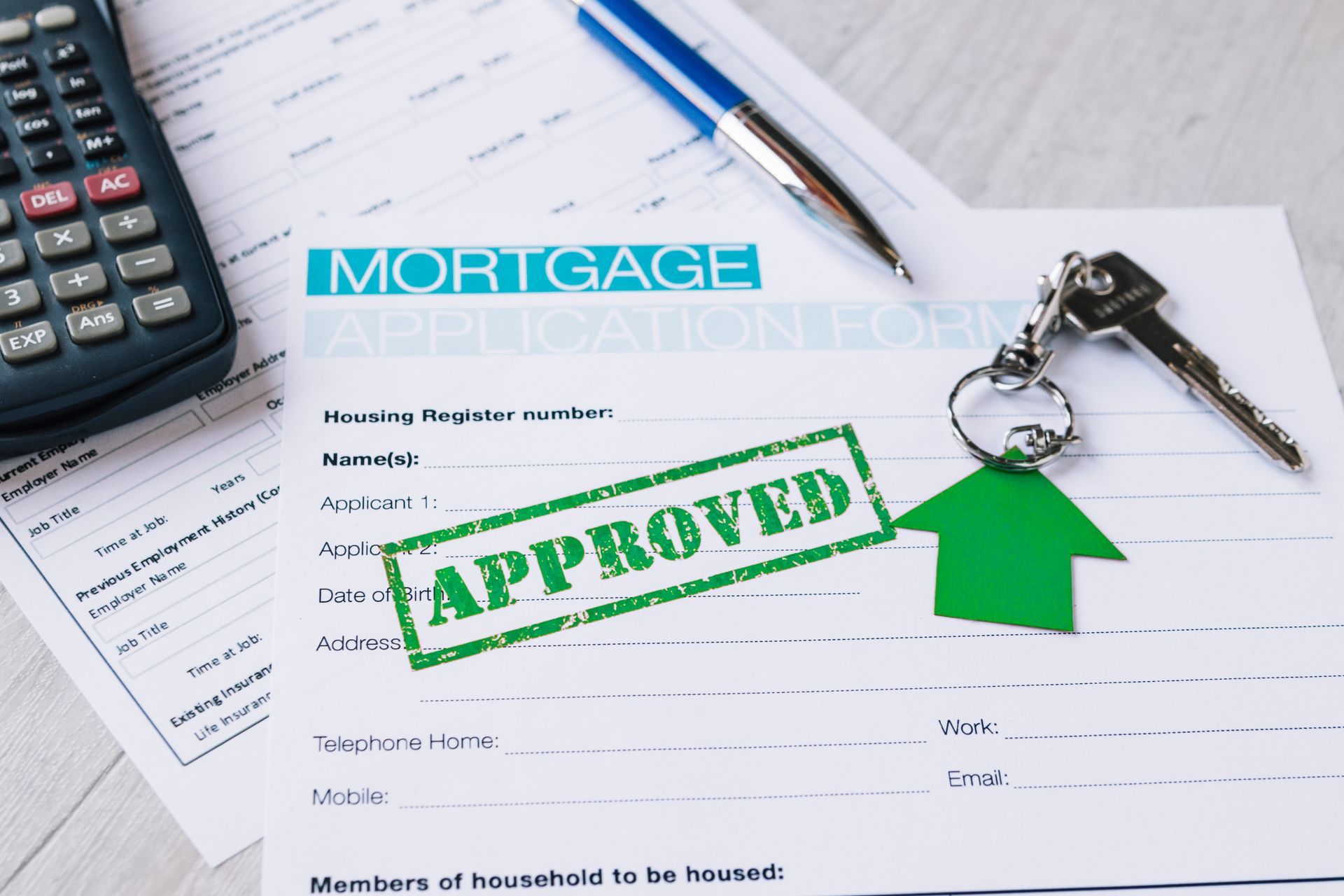 A mortgage application with a green approved stamp on it