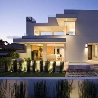 A large white house with a swimming pool in front of it