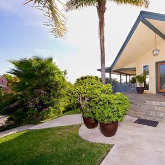 A house with potted plants in front of it