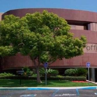 A large building with a lot of trees in front of it.