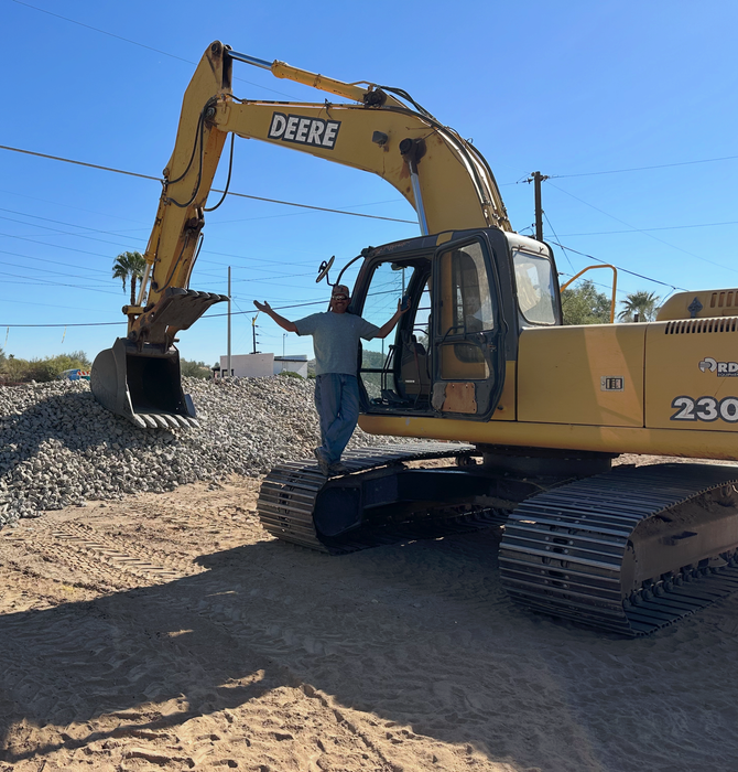 Big Dirt Excavating crew clearing land with a John Deere excavator in Wickenburg AZ