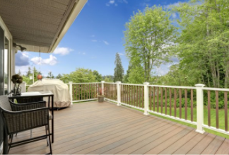 Fenced in wooden deck built in Cheyenne residential backyard