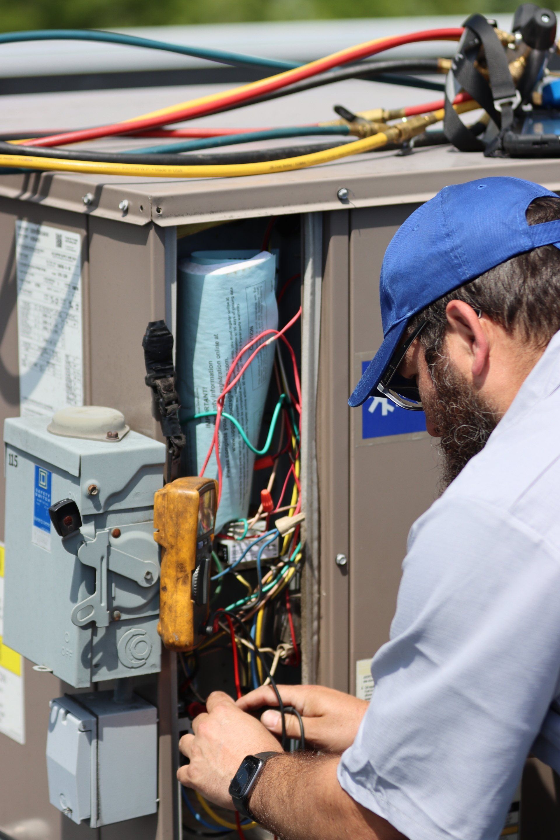 Technician Repairing Air Conditioner — Woodstock, IL — Jensen’s Plumbing & HVAC