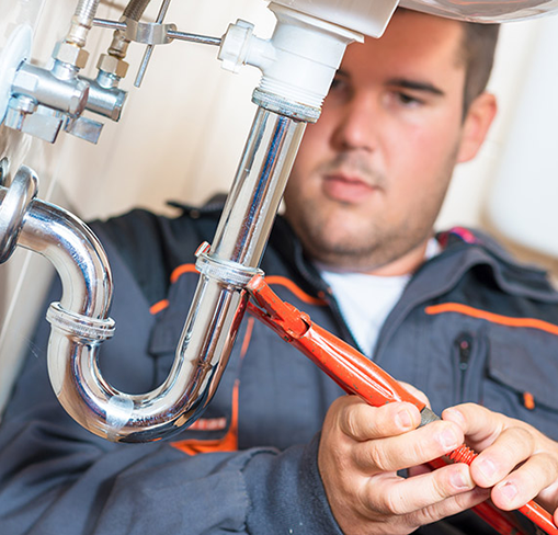 Technician Fixing Drain — Woodstock, IL — Jensen’s Plumbing & HVAC