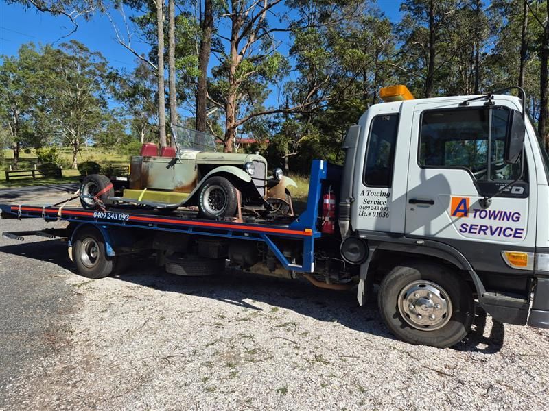 Tow Truck Transports a Vintage Convertible Car on a Sunny Day — A Towing Service In Coomba Park, NSW