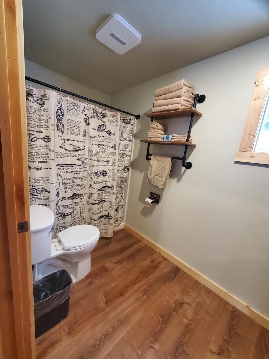 A bathroom with a toilet and a shower curtain