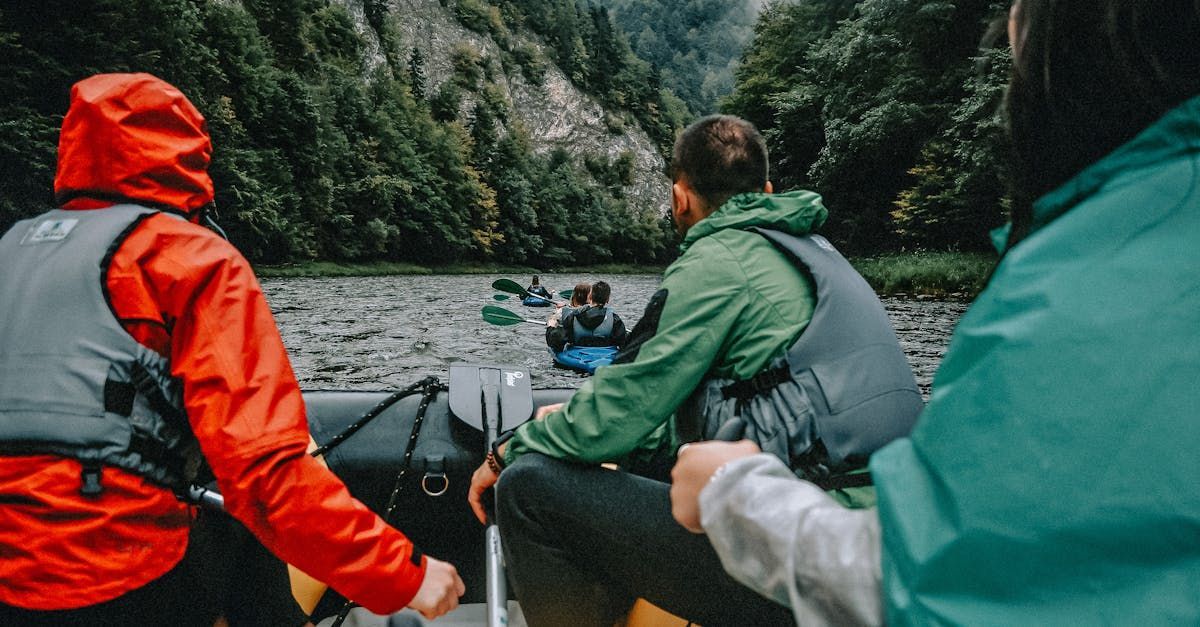 A group of people are sitting in a boat on a river.