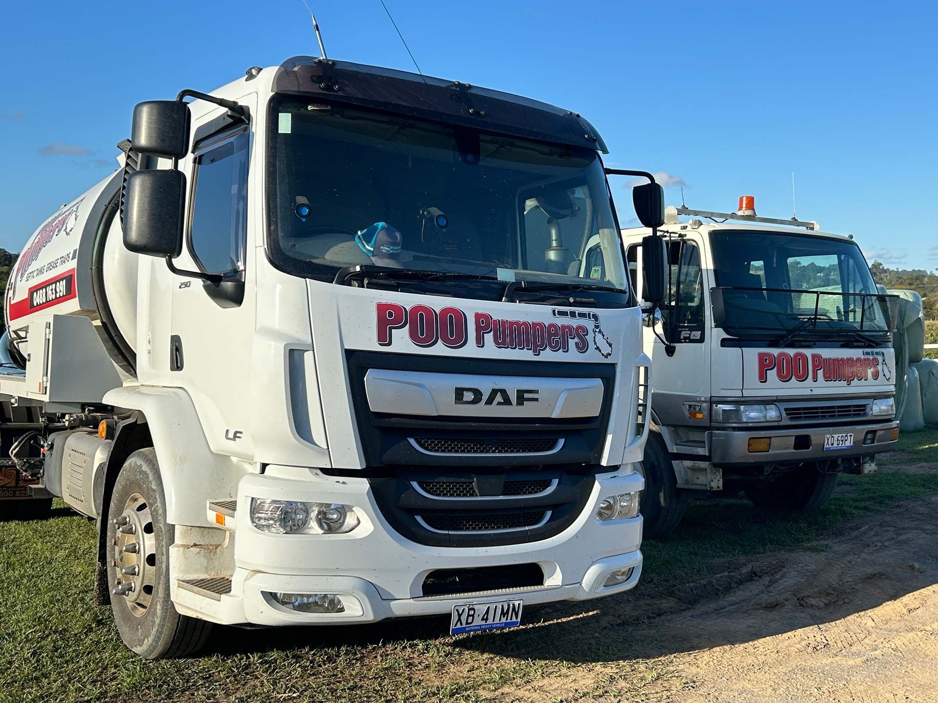 Two Septic Tank Trucks Parked Next To Each Other — Gympie Poo Pumpers in Southside, QLD 