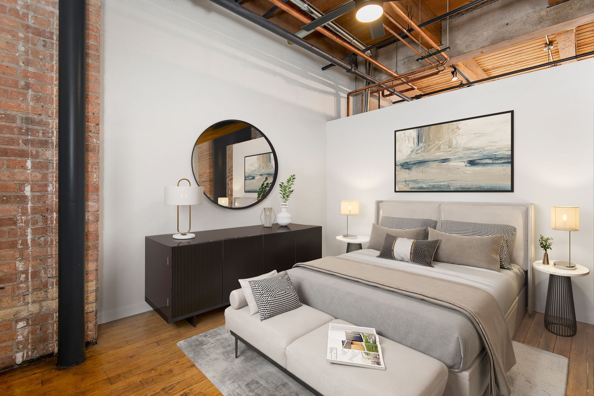 A bedroom with a large bed , a couch , a mirror and a dresser at The Lofts at Gin Alley.