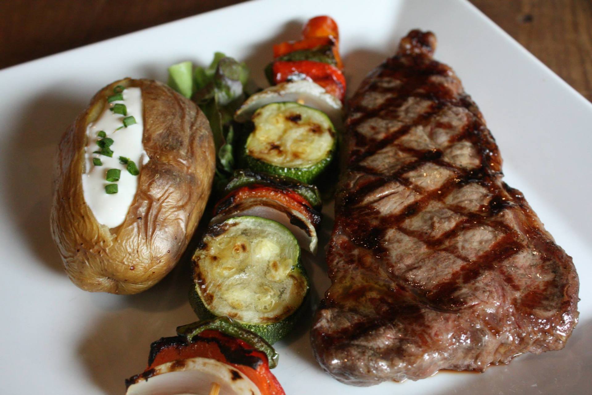 NY Strip steak w/baked potato and vegetables