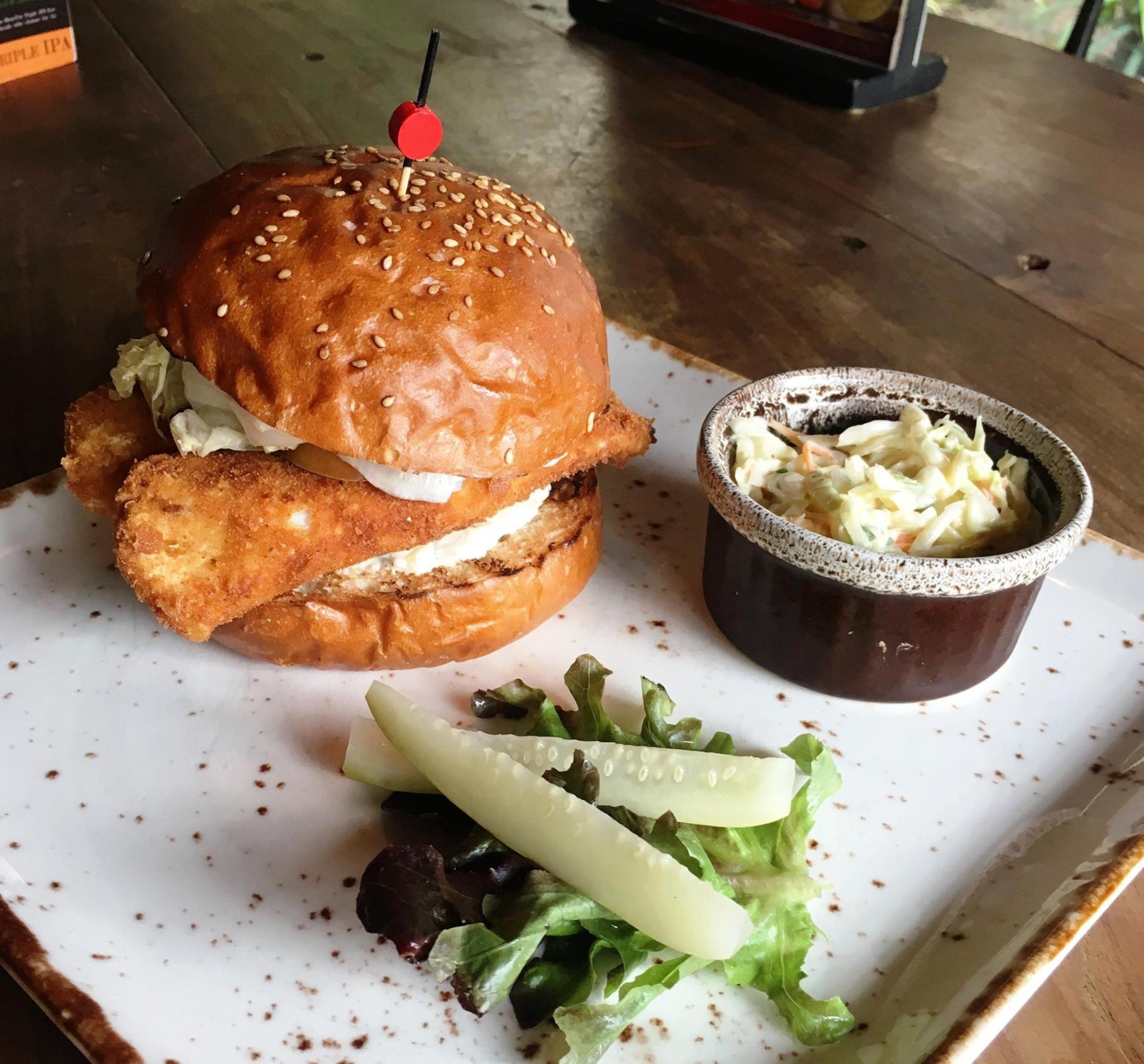 A plate of food with a sandwich and coleslaw on it