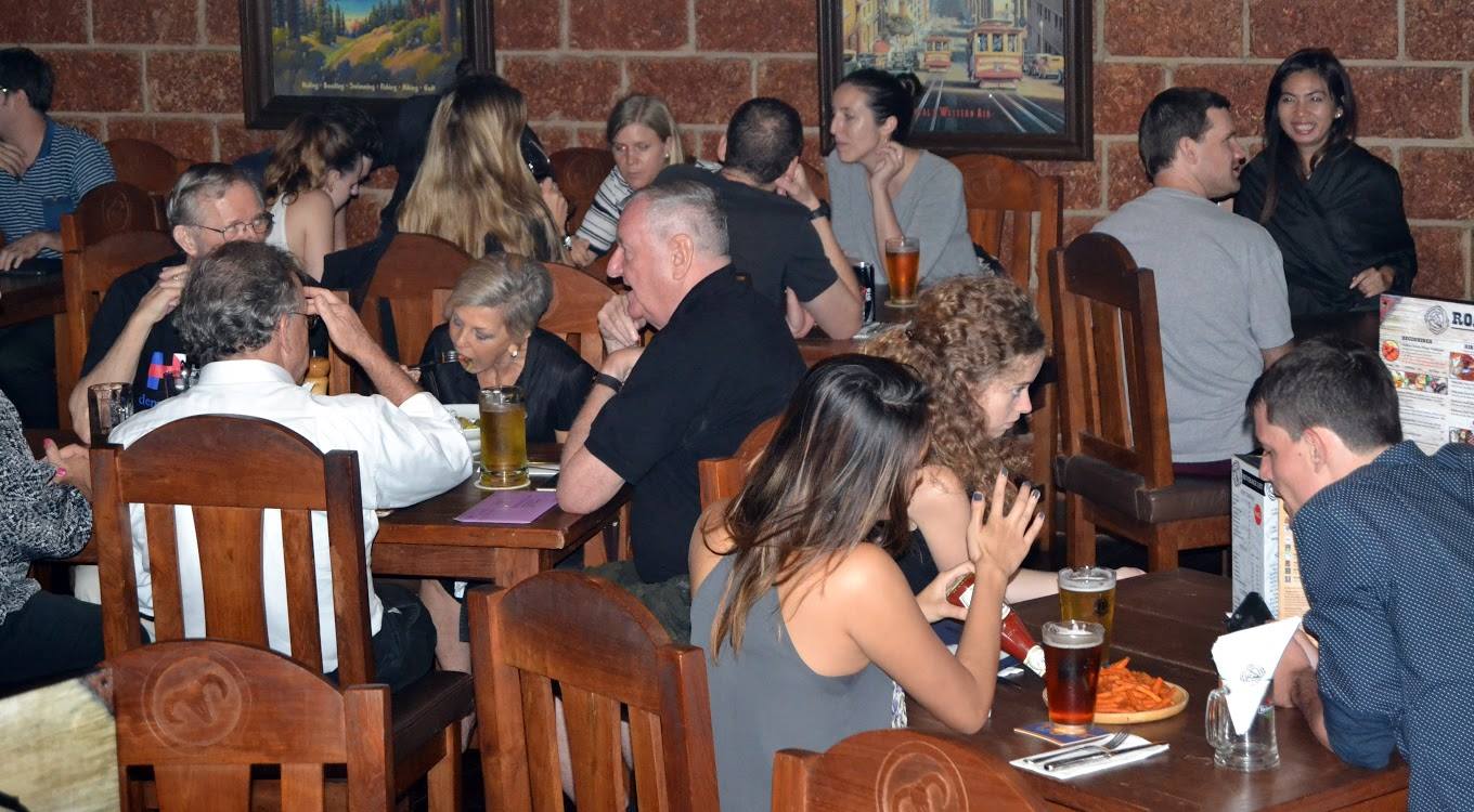 A group of people are sitting at tables in a restaurant