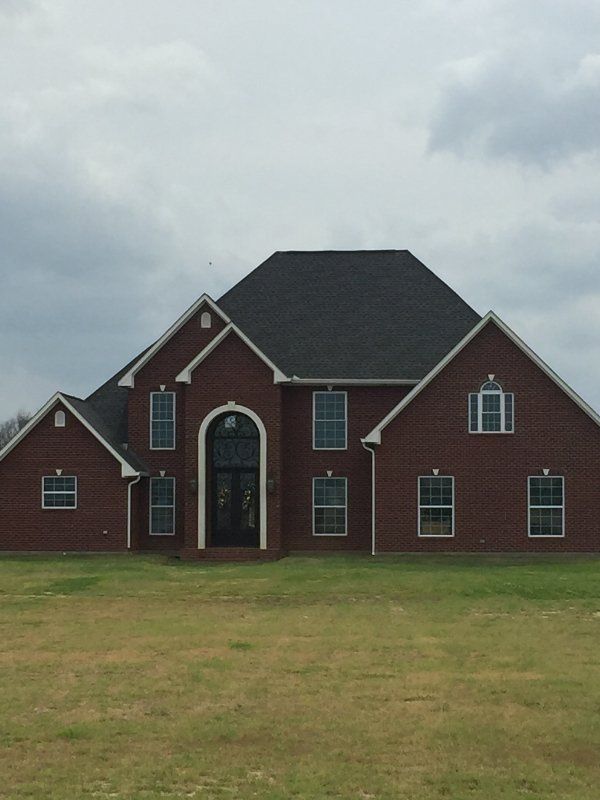 large brick house with tall roofs