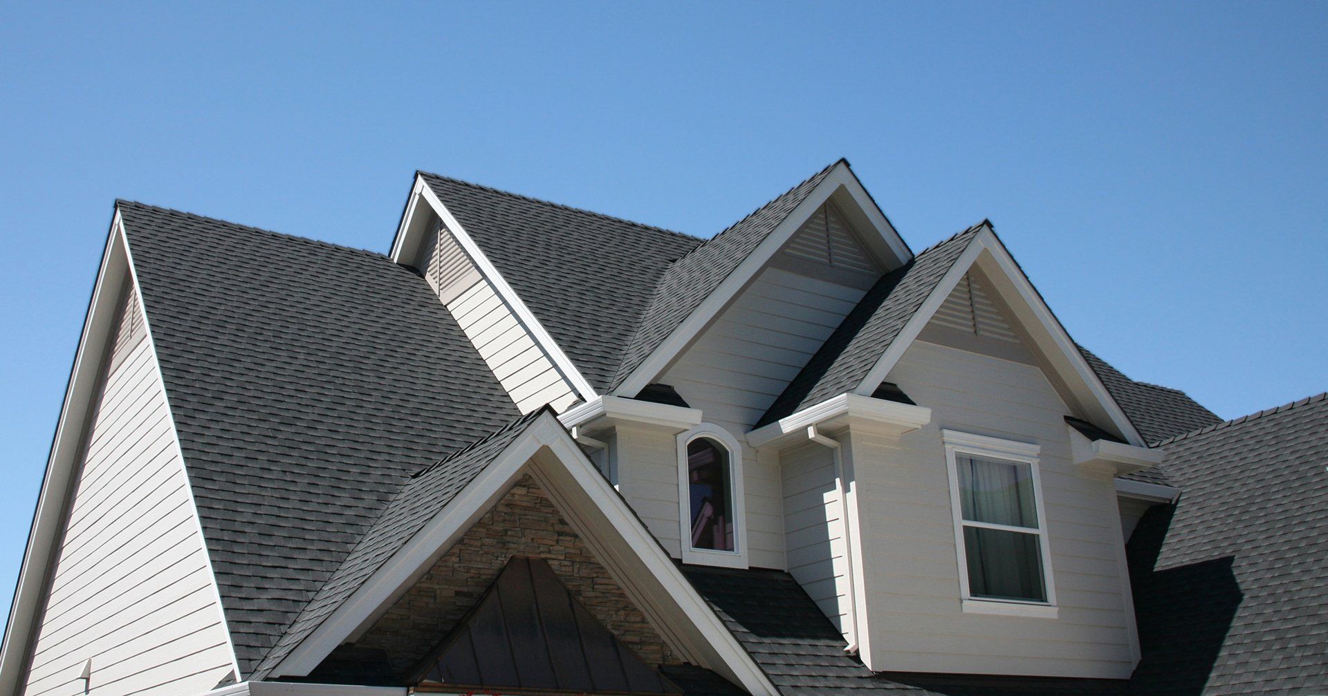Grey shingles on white suburban house