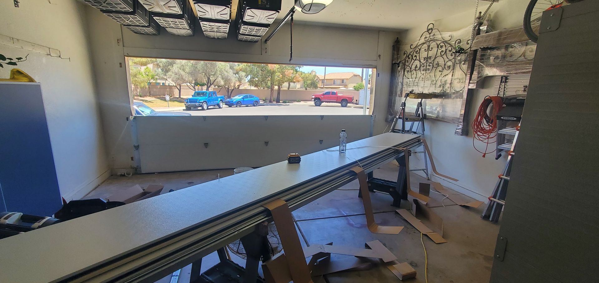 A garage with a large window and a long table.