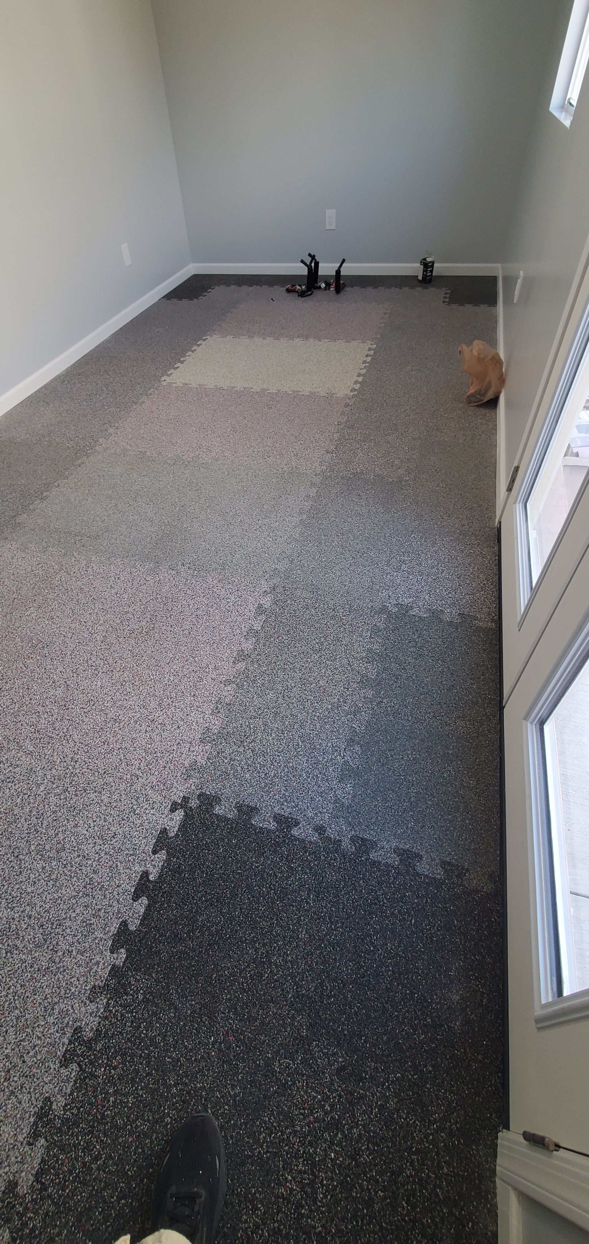 A room with a lot of carpet on the floor and a door.