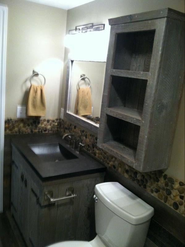 A bathroom with a toilet a sink and a mirror