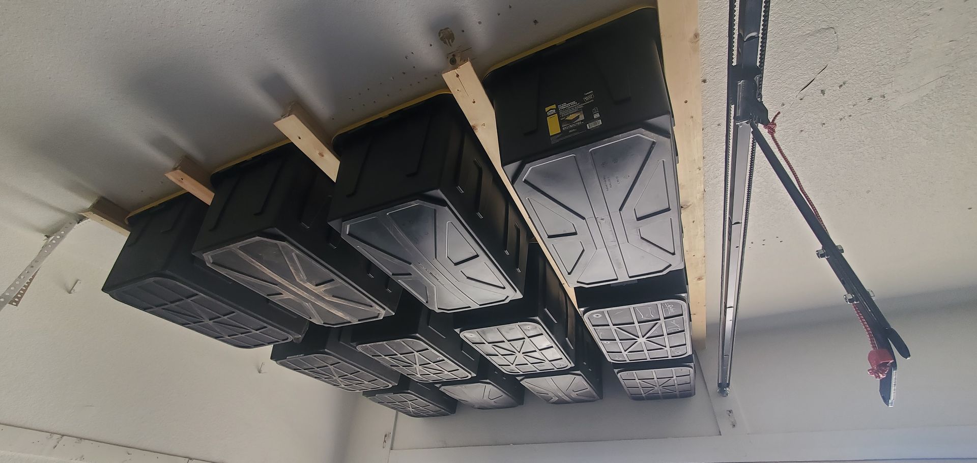A bunch of boxes are hanging from the ceiling in a garage