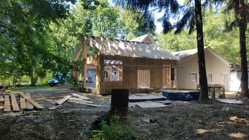 A house is being built in the middle of a forest.
