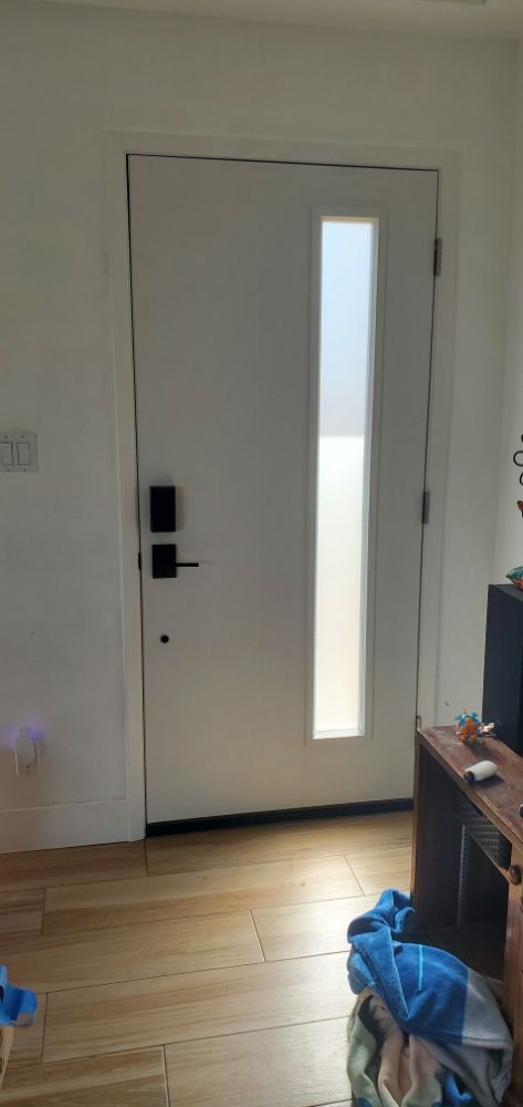 A white door with a window in a living room.