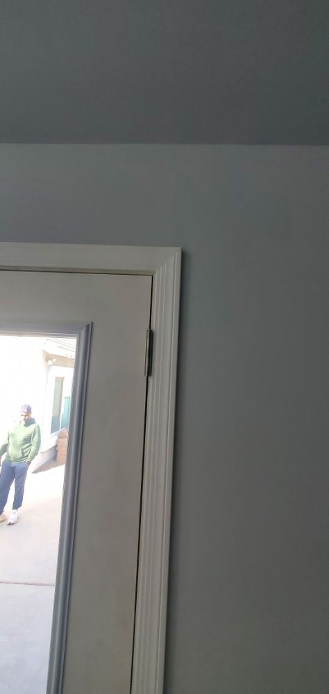 A close up of a door with a person standing in the background.