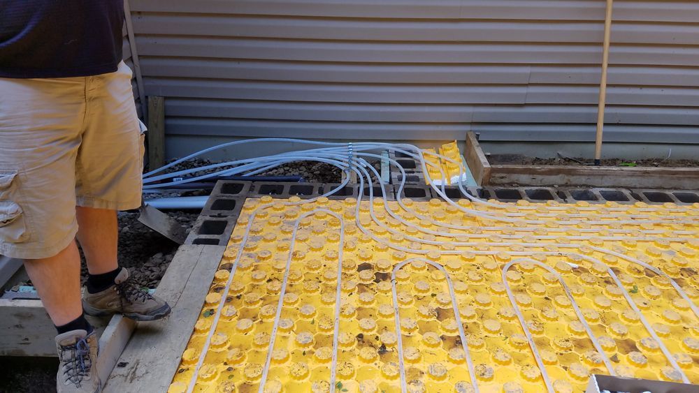 A man is standing on a yellow tile floor.