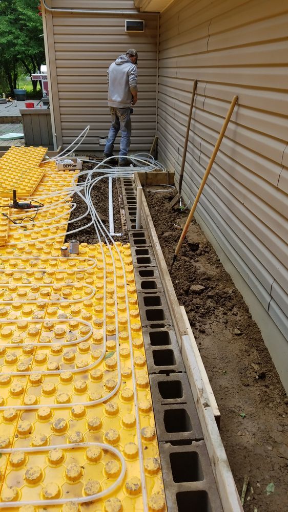 A man is working on the side of a house.