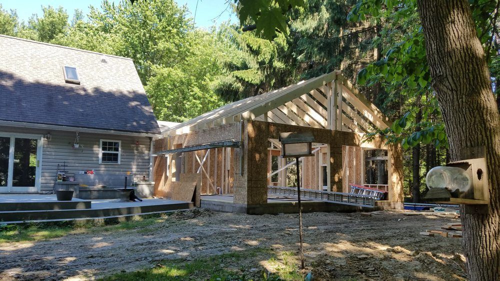 A house is being built in the middle of a forest.