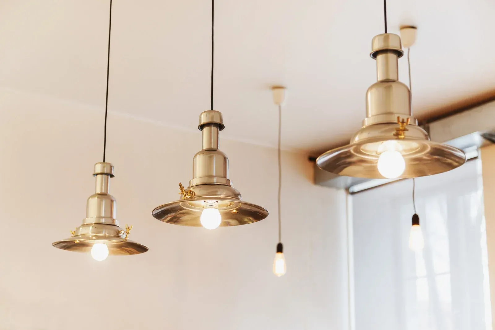 Three pendant lights are hanging from the ceiling in a room.