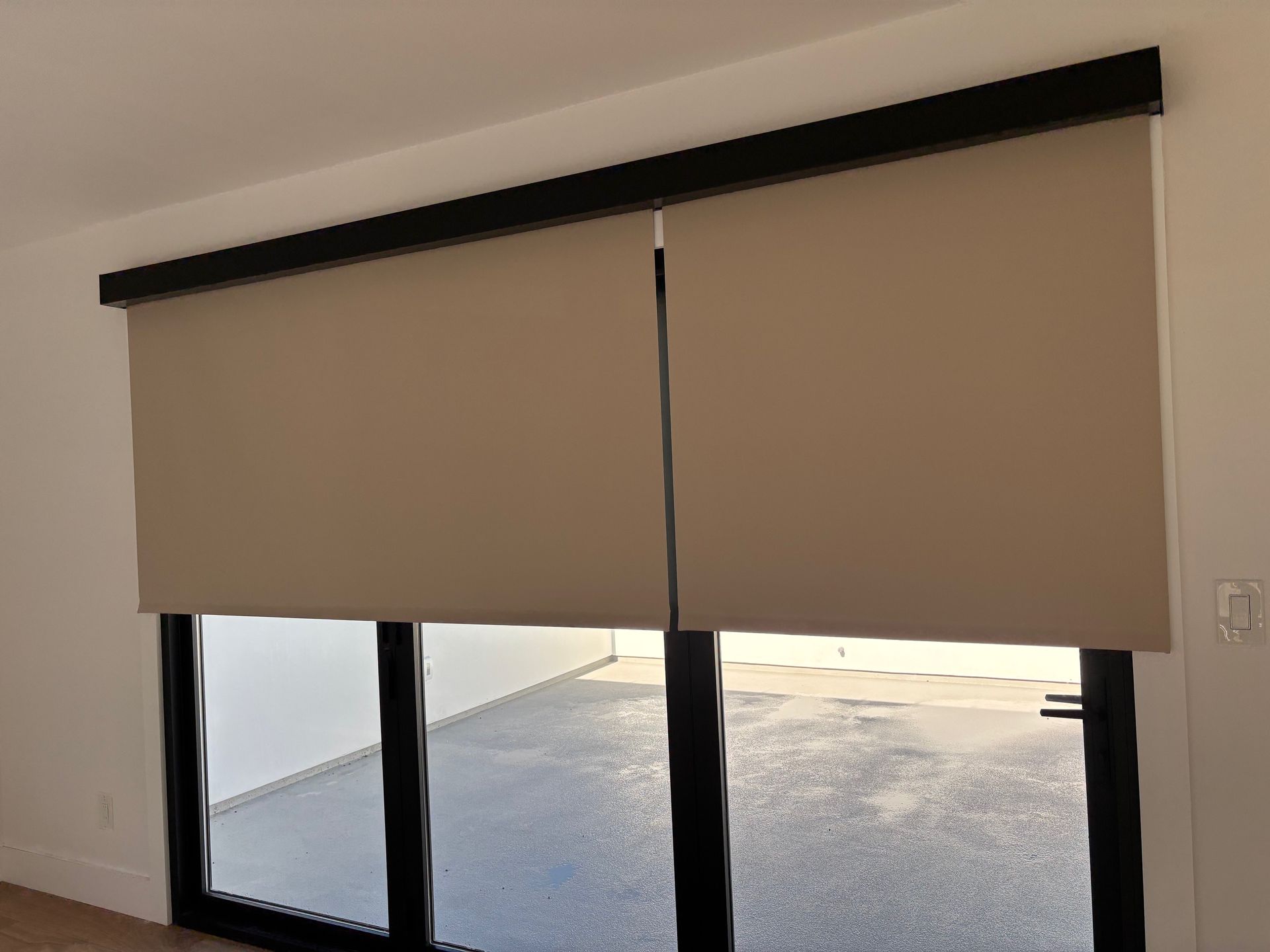 A white truck is parked in a parking lot next to a building.