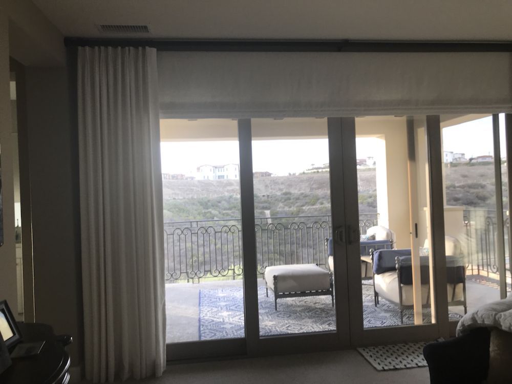 Interior view of a room with sliding glass doors opening onto a balcon