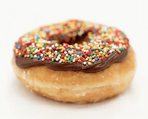 A donut with chocolate frosting and sprinkles on a white background