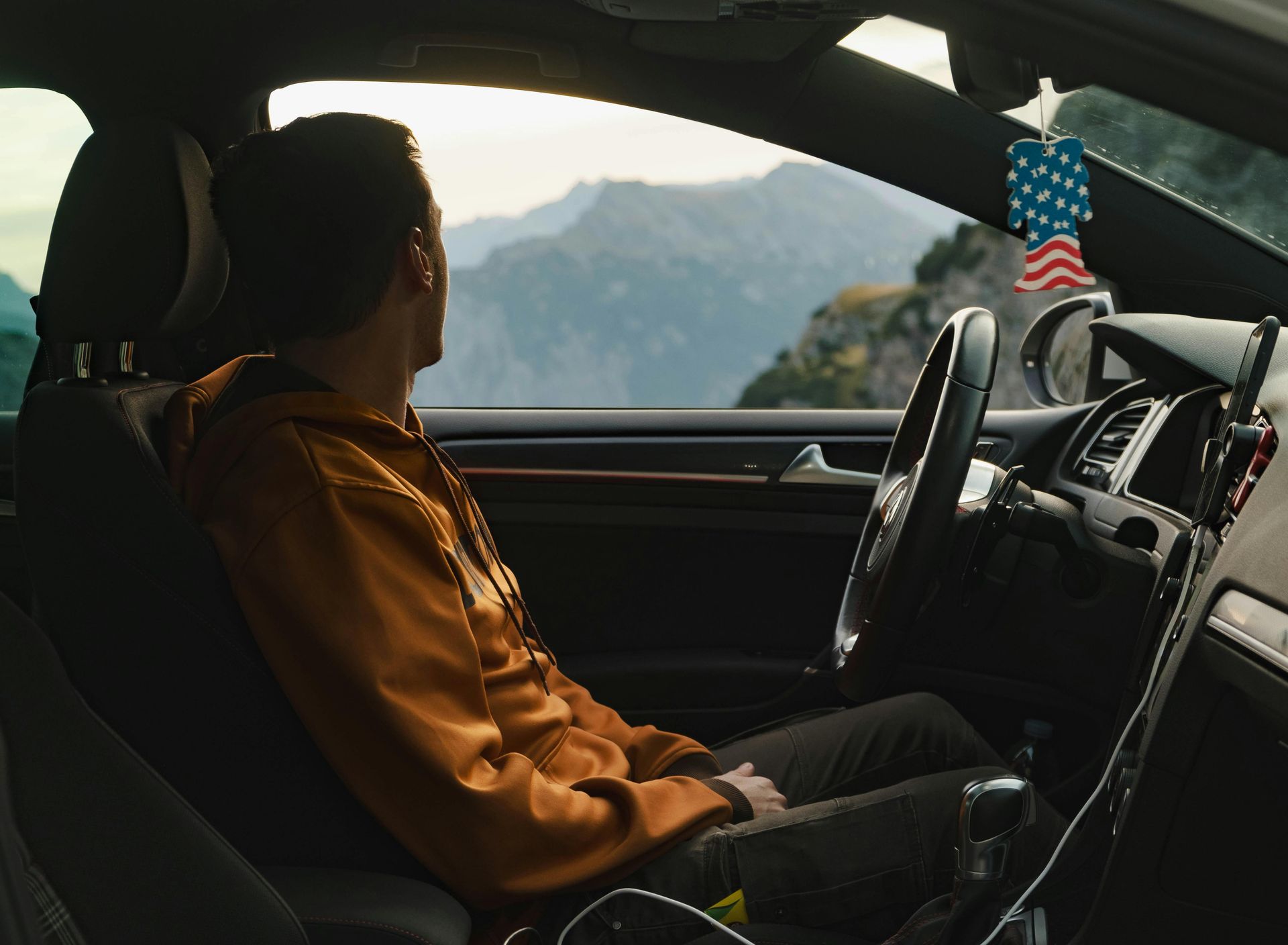person sitting in car looking out window