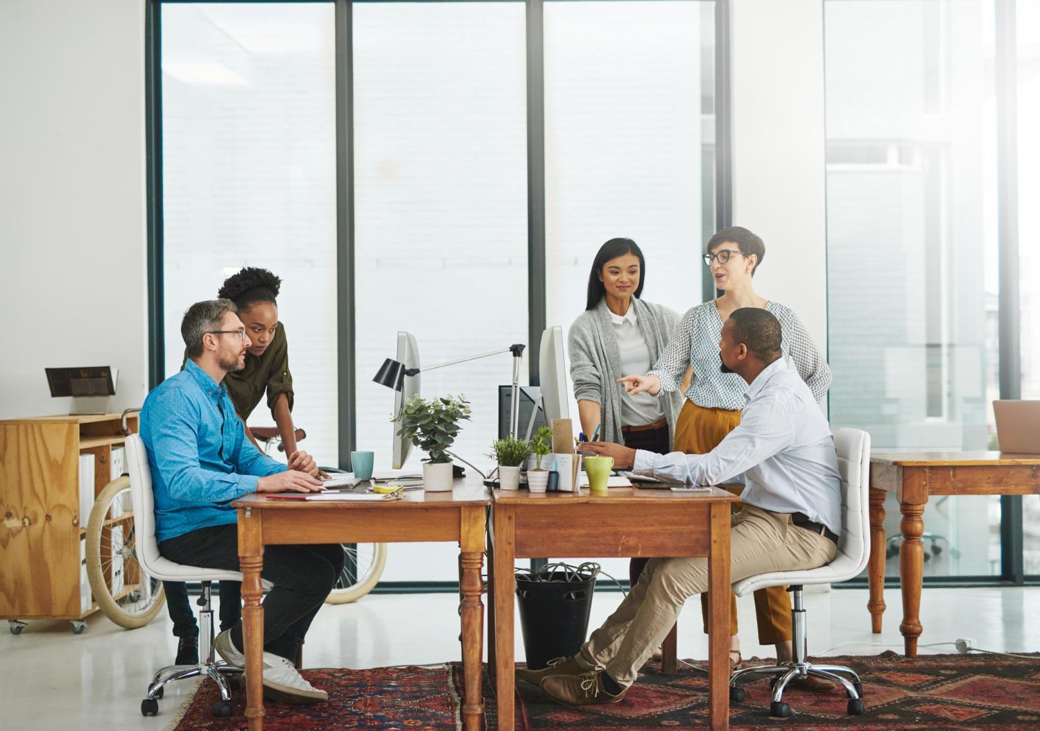 Two business professionals in suits reviewing documents, discussing strategy.