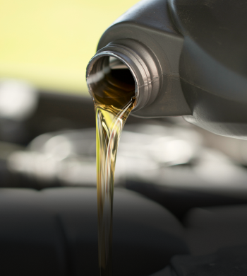 Oil being poured into vehicle of car | Roe Jan Auto Center LLC
