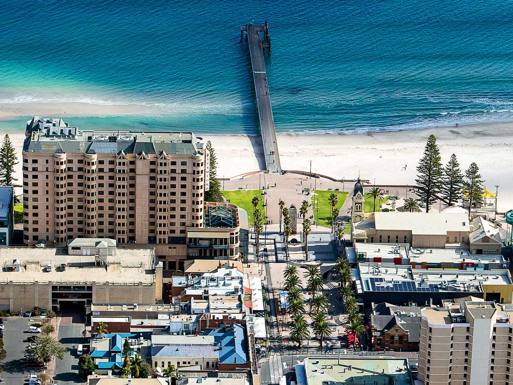 Aerial photo of beach with bridge into the water