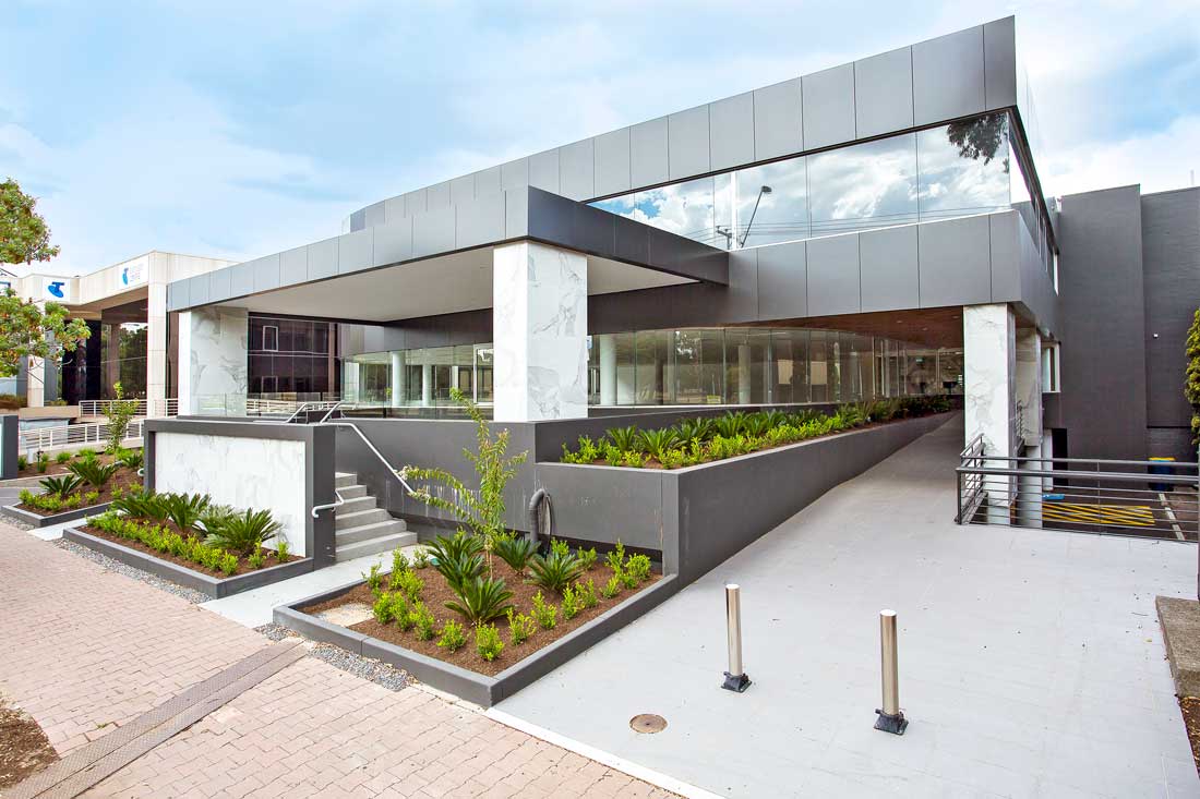 Architectural photo of nice building with plants around it
