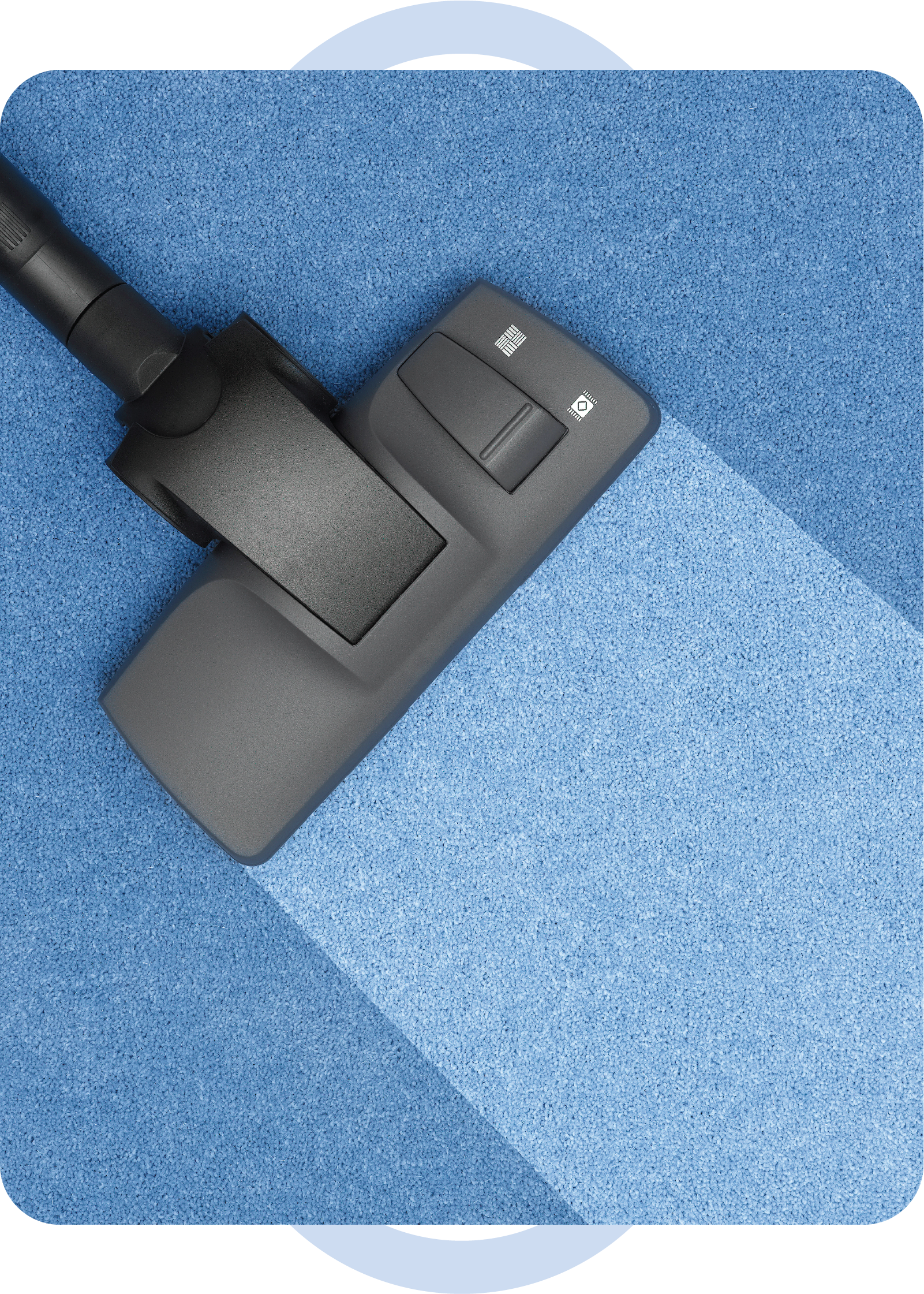 A vacuum cleaner is cleaning a blue carpet.