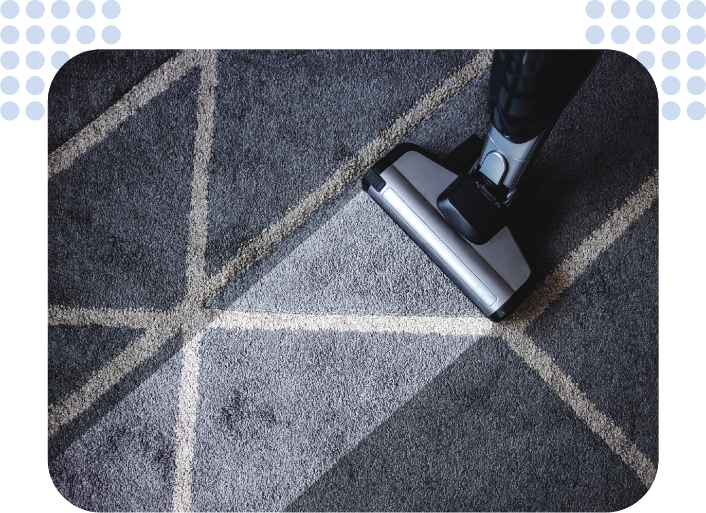 A person is using a vacuum cleaner to clean a carpet.