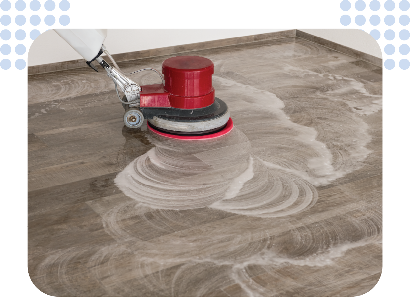 A person is cleaning a wooden floor with a machine.