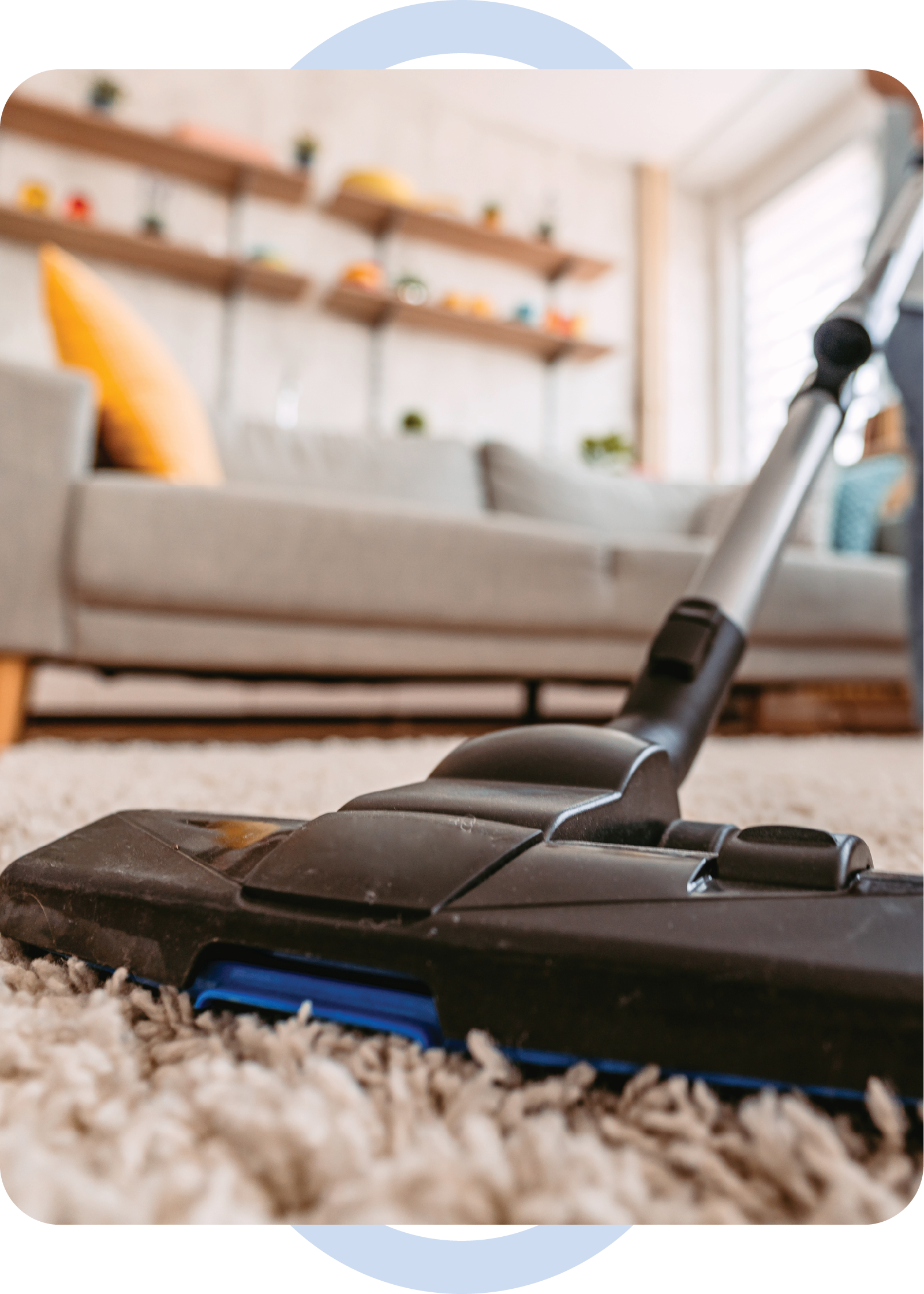 A vacuum cleaner is sitting on a carpet in a living room.